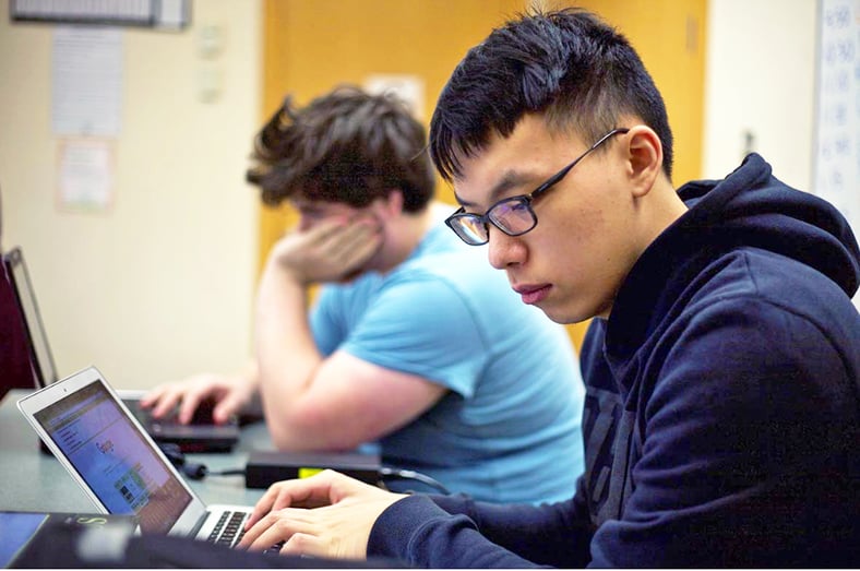 Student using computer in classroom